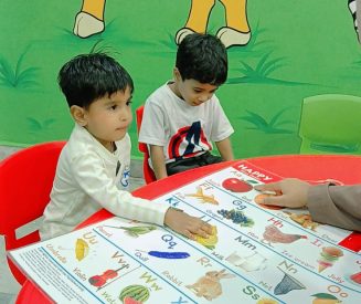 "Teacher guiding children in preschool learning session"