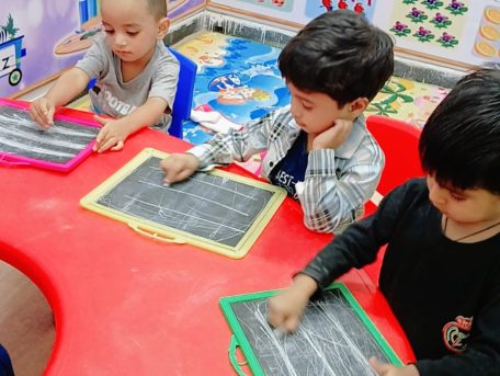 "Teacher guiding children in preschool learning session"