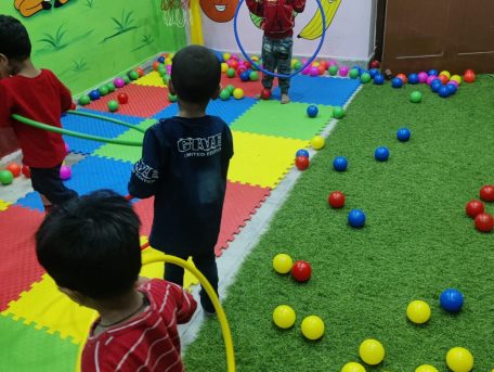 "Children playing with toys in daycare activity center"