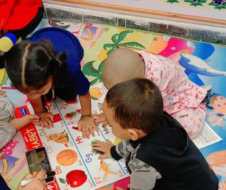 "Teacher guiding children in preschool learning session"
