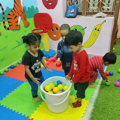 "Children playing with toys in daycare activity center"